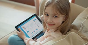 A girl holding a tablet displaying messages of support